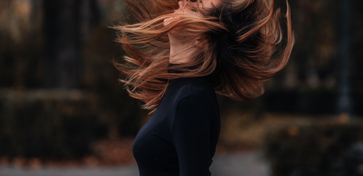 woman in black long sleeve shirt standing on road during daytime