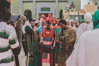 people in traditional dress standing on the street during daytime