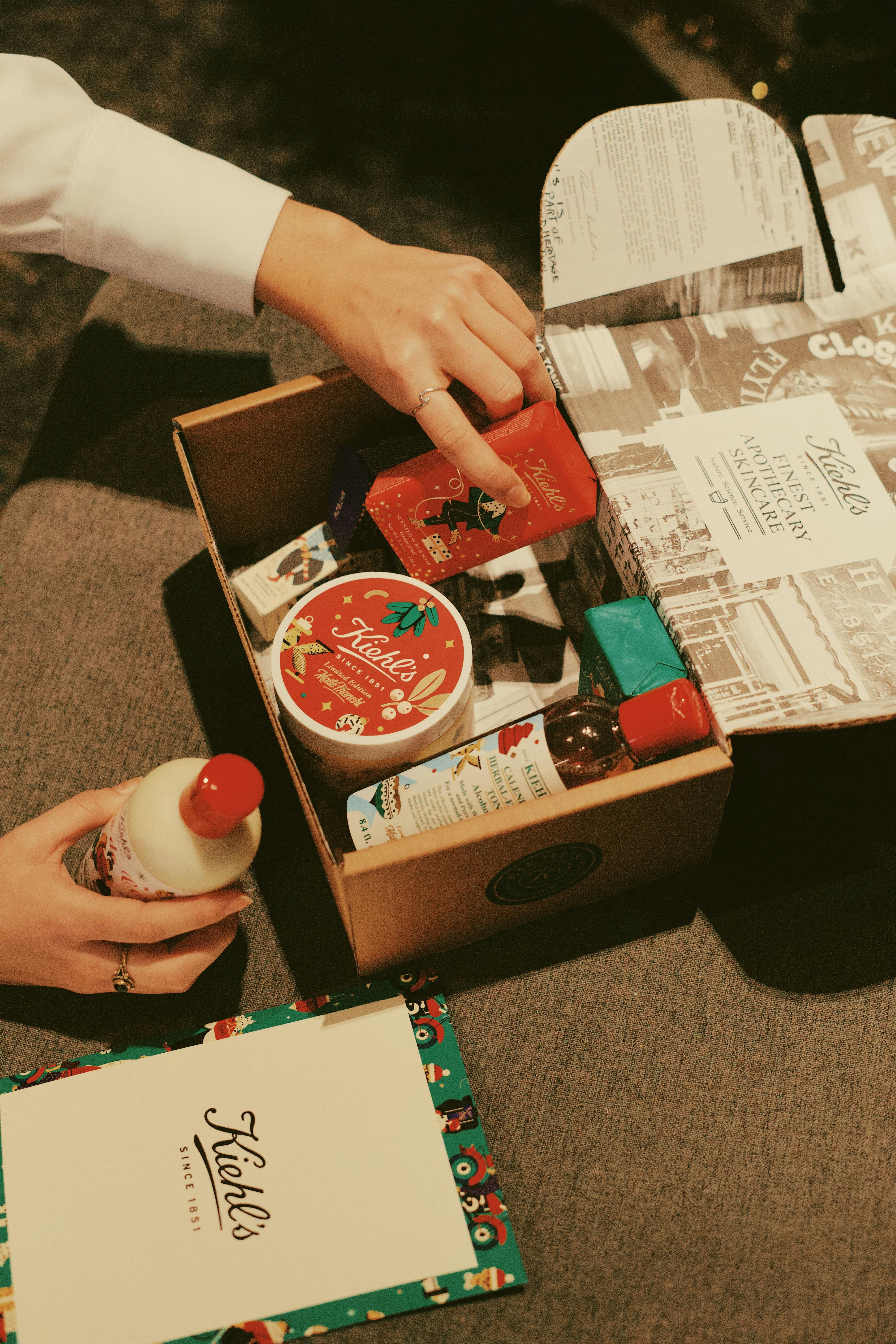 person holding red and white box