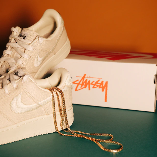 A single white Nike Air Force 1 Low sneaker photographed against a plain backdrop