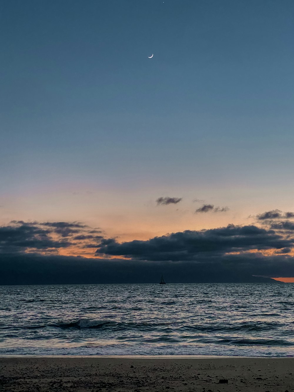 body of water under cloudy sky during sunset