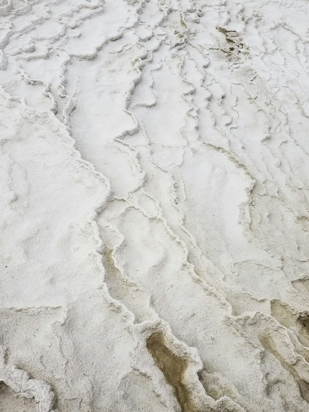 white and gray sand during daytime