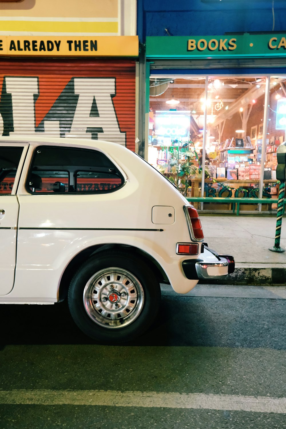 white car parked beside store