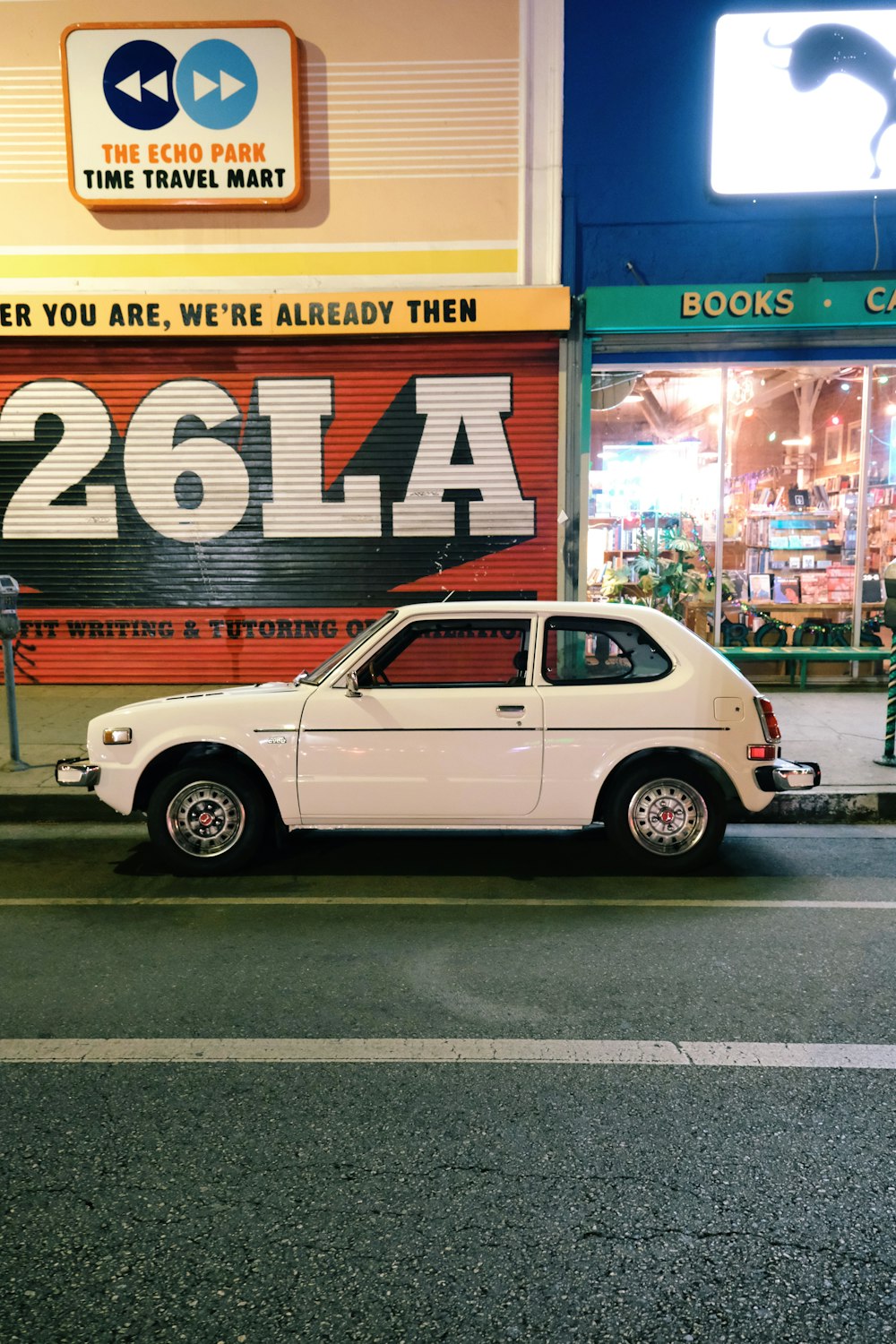 white sedan parked beside store