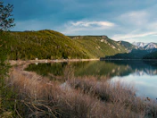 Green grass beside a lake under a blue sky