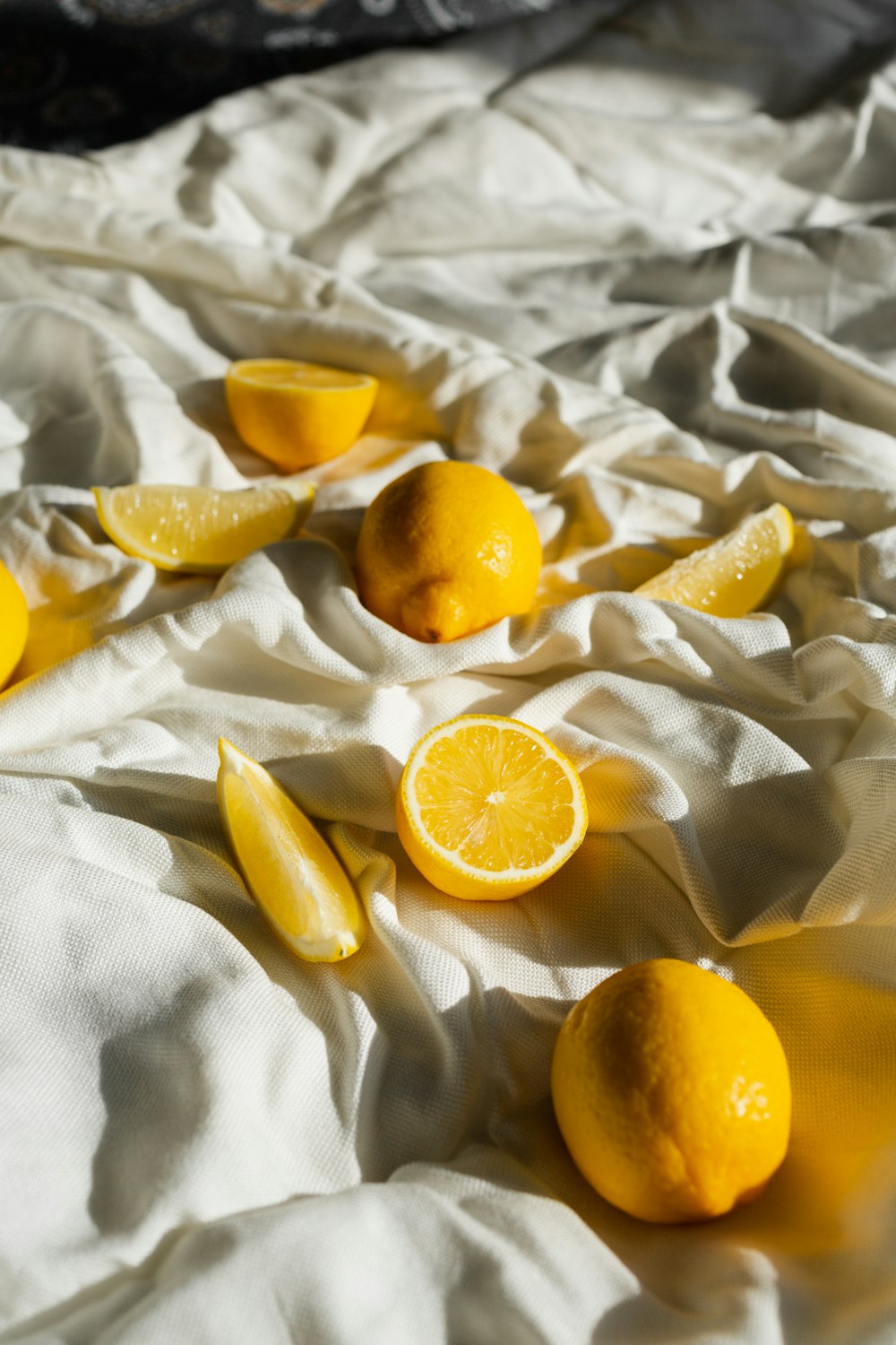 yellow citrus fruit on white textile