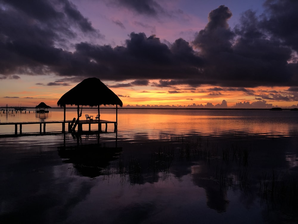 silhouette of beach house during sunset