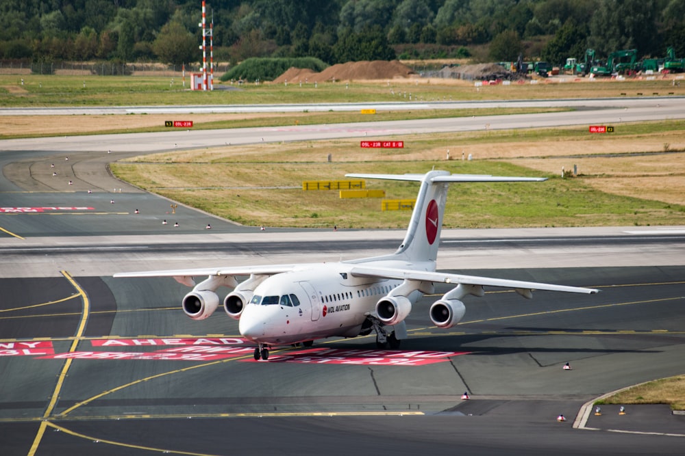 avião de passageiros branco no aeroporto durante o dia