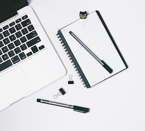 Minimalistic workspace with a laptop and game design notes