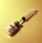 A single syringe and vial labeled 'VACCINE COVID-19 Injection Only' are placed on a smooth surface with a soft yellow background. The syringe is filled with a small amount of fluid and is attached to the vial via a needle.