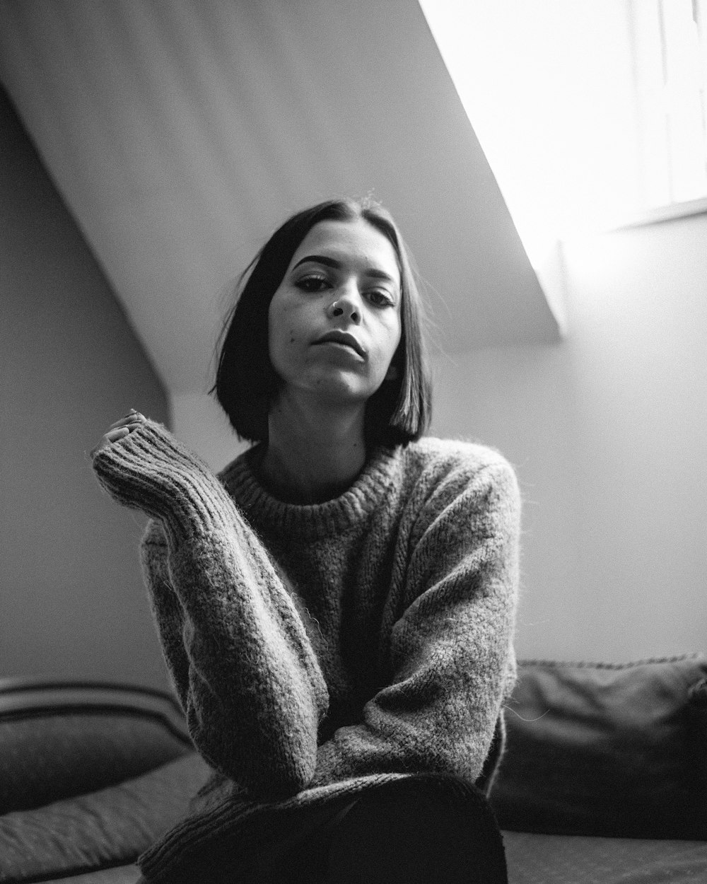 woman in sweater sitting on couch