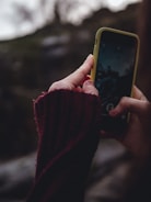 person holding yellow iphone 5 c