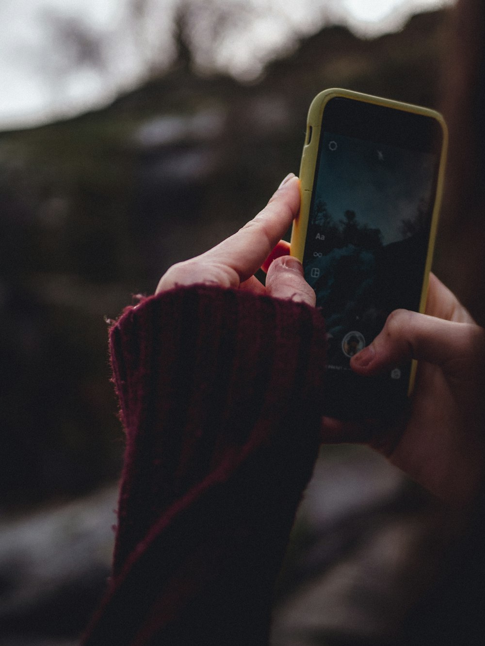 person holding yellow iphone 5 c