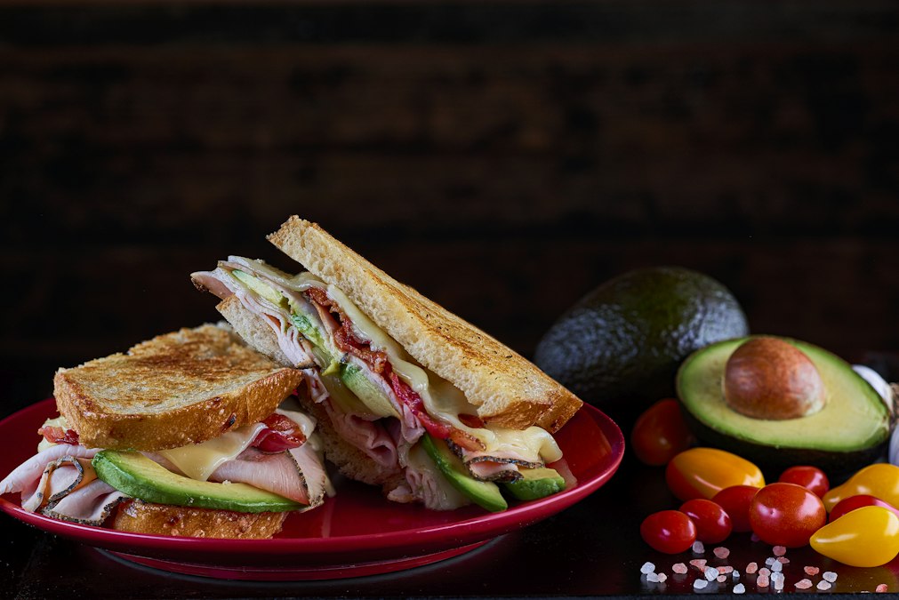 Toasted turkey sandwich on a red plate — one of the fastest leftover turkey meals