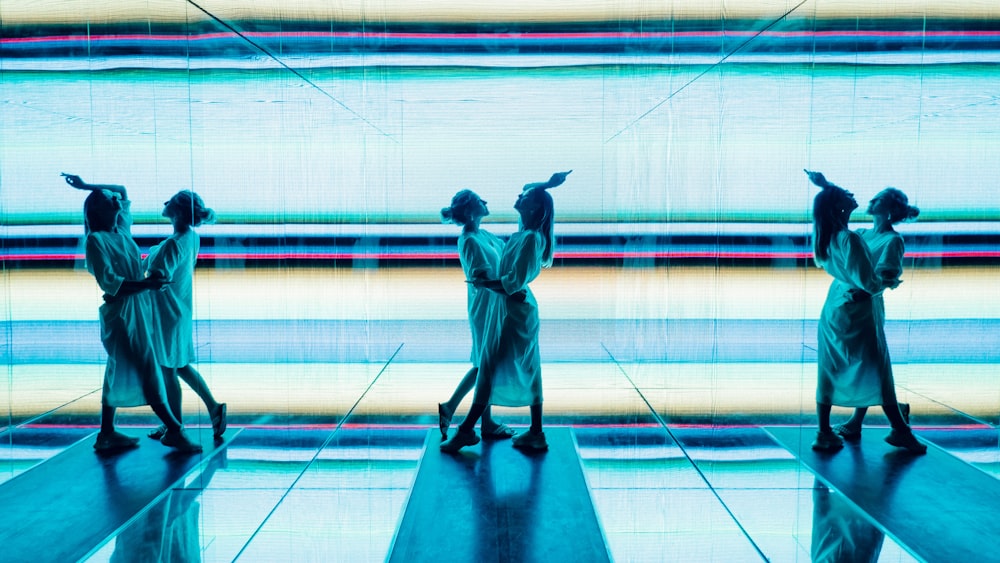 man in blue robe standing on blue floor