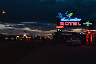 A beautifully lit luxury motel entrance at dusk, inviting guests inside.