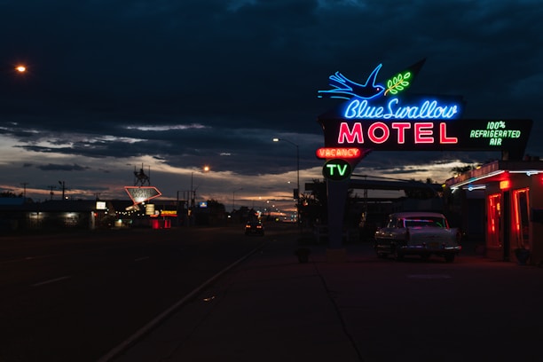 A beautifully lit luxury motel entrance at dusk, inviting guests inside.