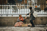 A volunteer gently handing a warm meal to a grateful family in a cozy community center.