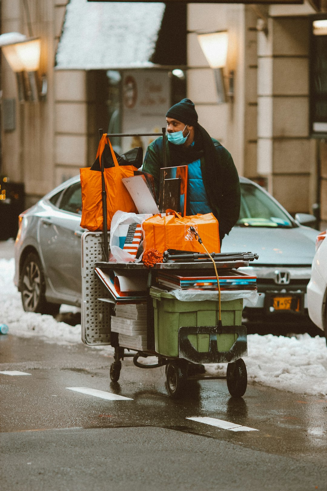 man in black jacket and black pants sitting on black plastic cart