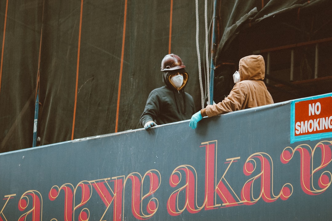 2 person wearing brown jacket and black helmet