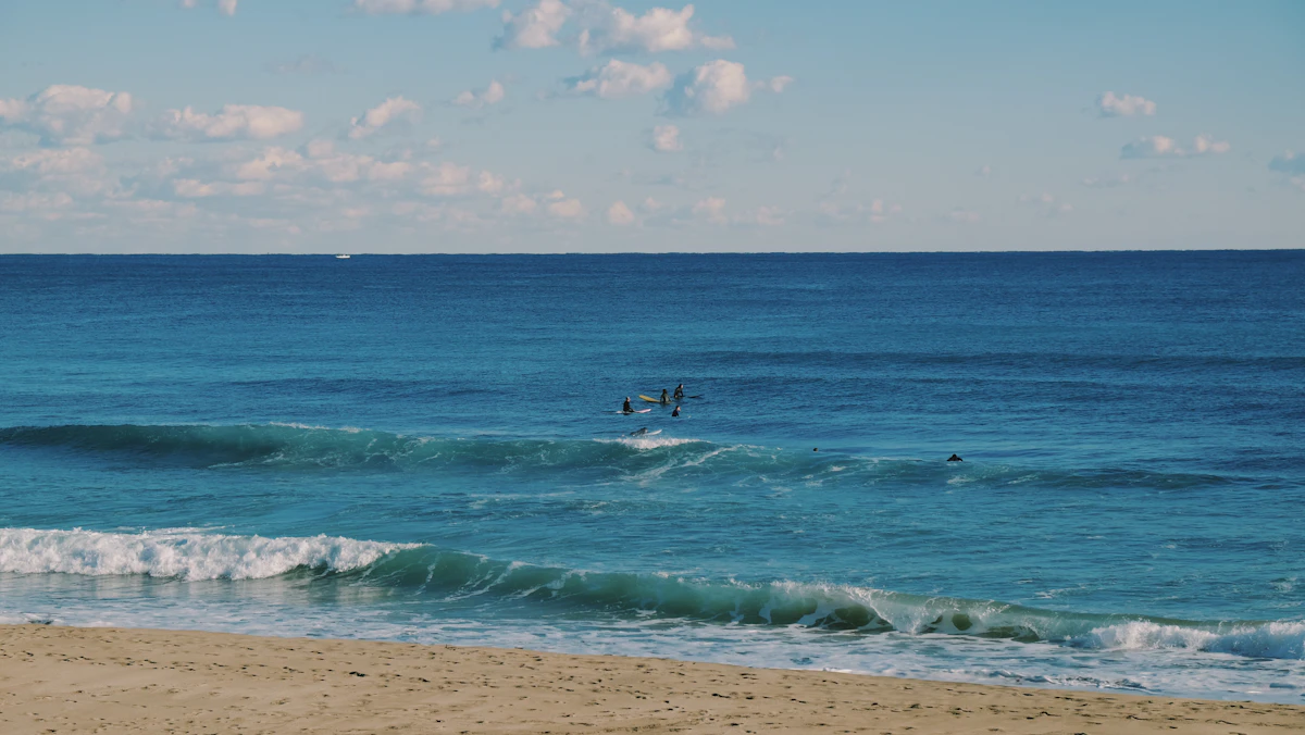 A surfer riding a wave off the coast of Japan