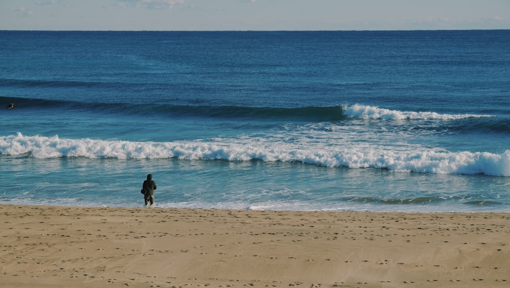 person walking on beach during daytime