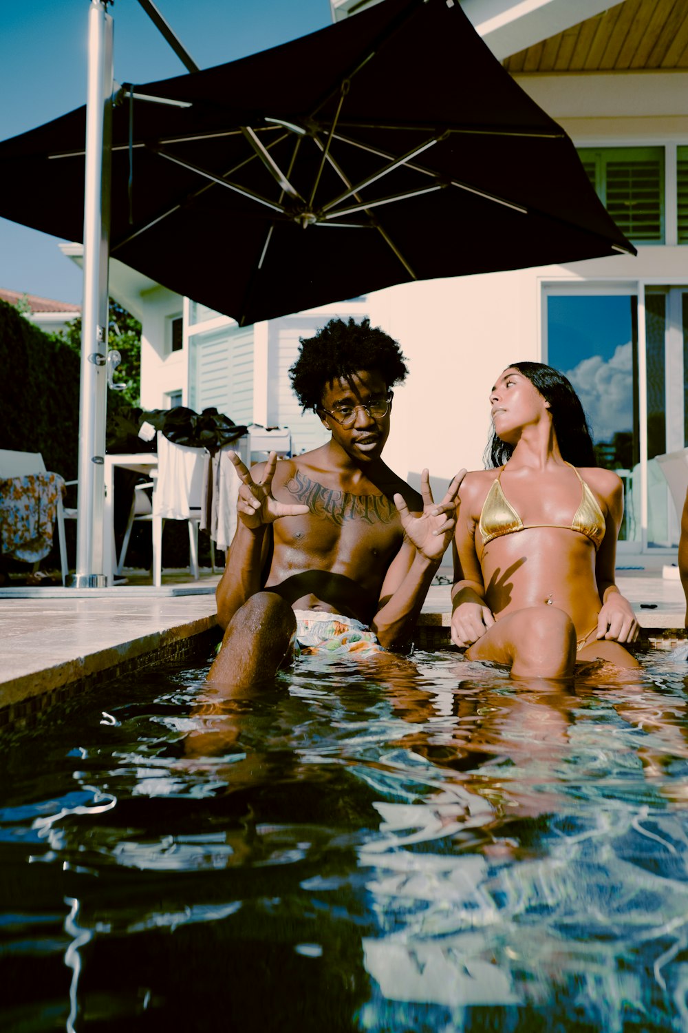 2 women in swimming pool during daytime