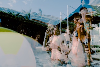 woman in white dress shirt and black sunglasses standing beside water fountain during daytime