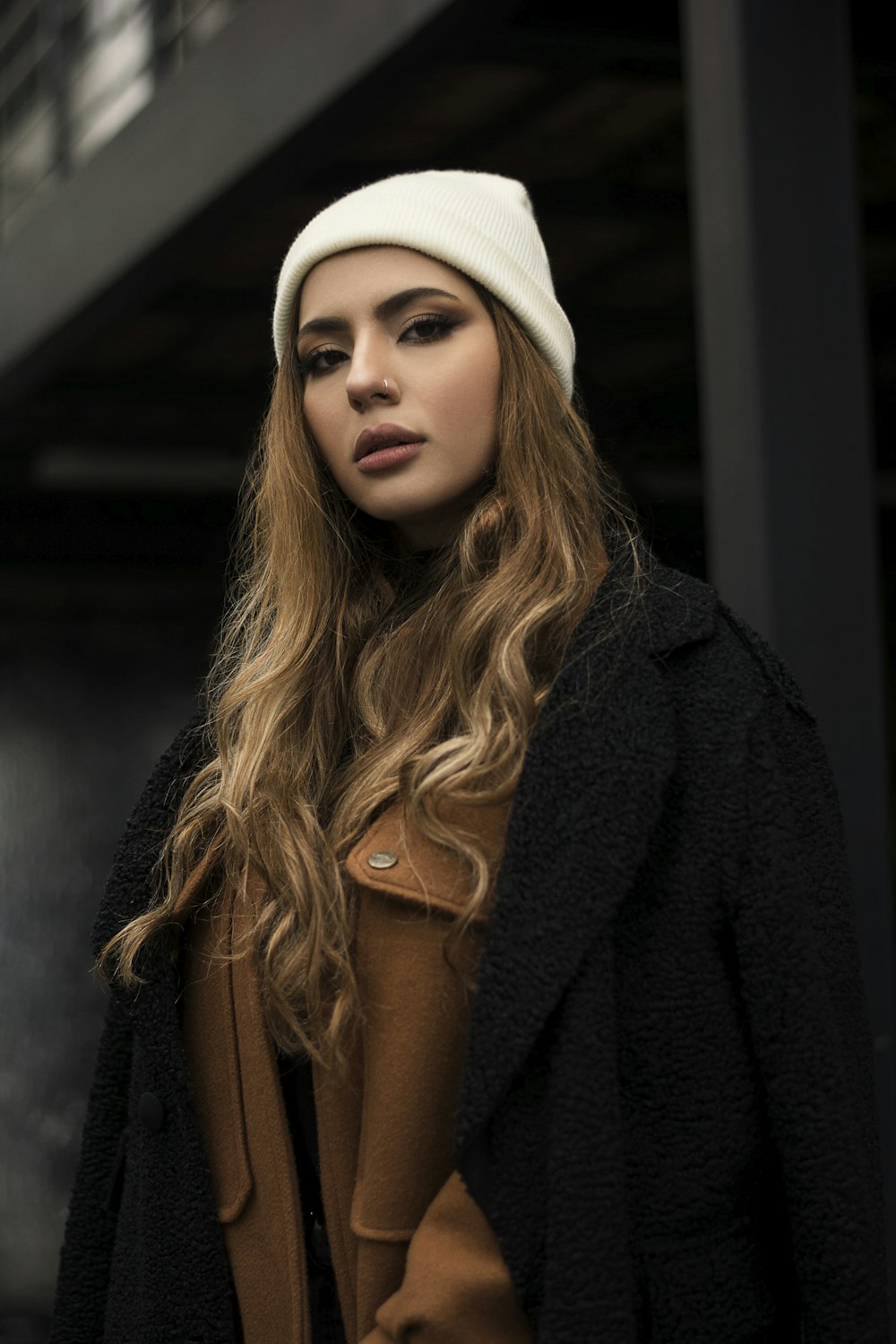woman in black coat and white knit cap