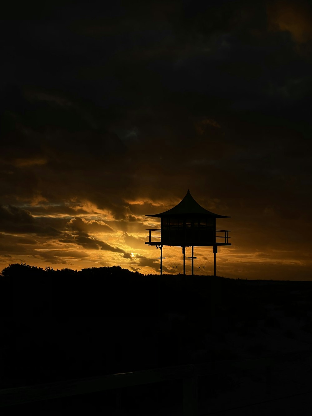 silhouette of house during sunset