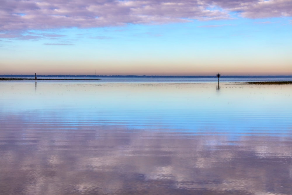 calm sea under orange sky during sunset