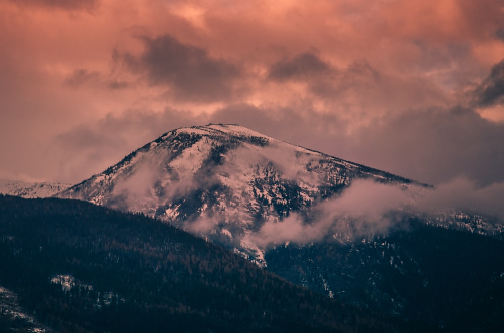 snow covered mountain under cloudy sky during daytime