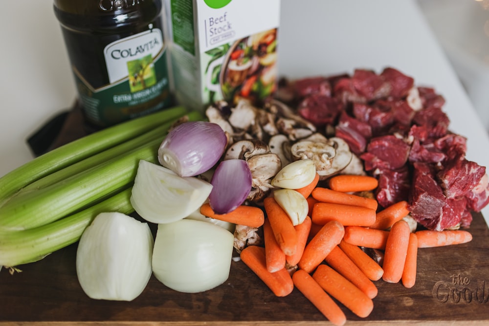 sliced carrots and white onions on brown wooden table