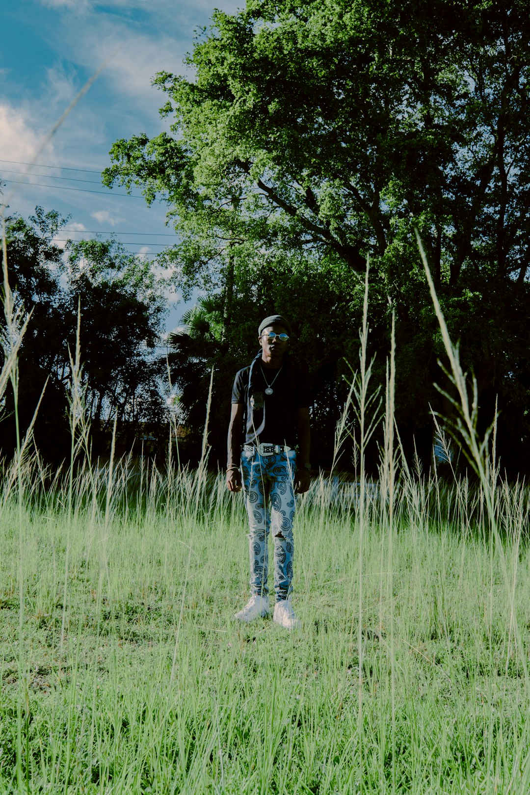 woman in black jacket standing on green grass field during daytime