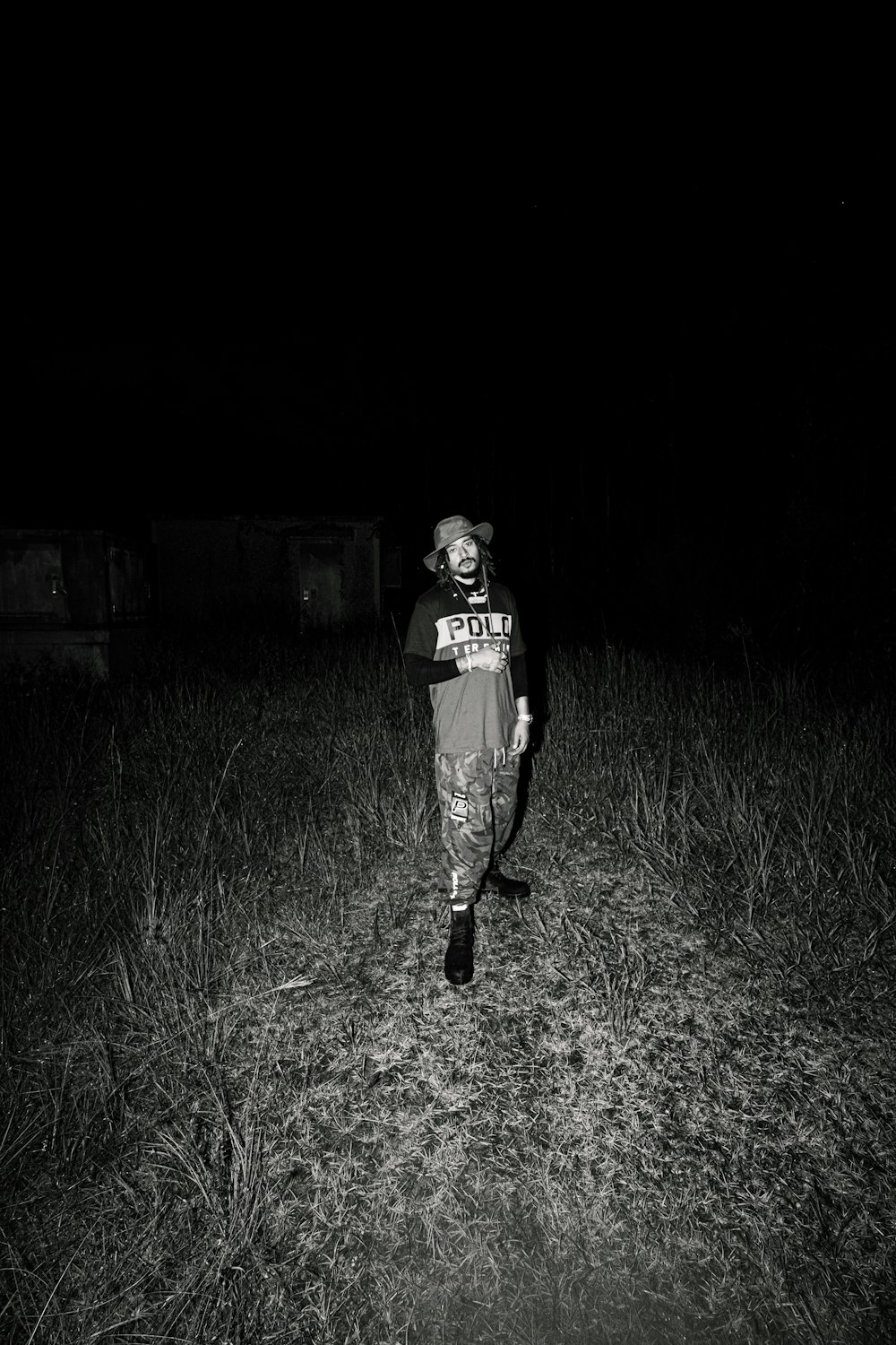 woman in black and white t-shirt and black pants standing on green grass field during