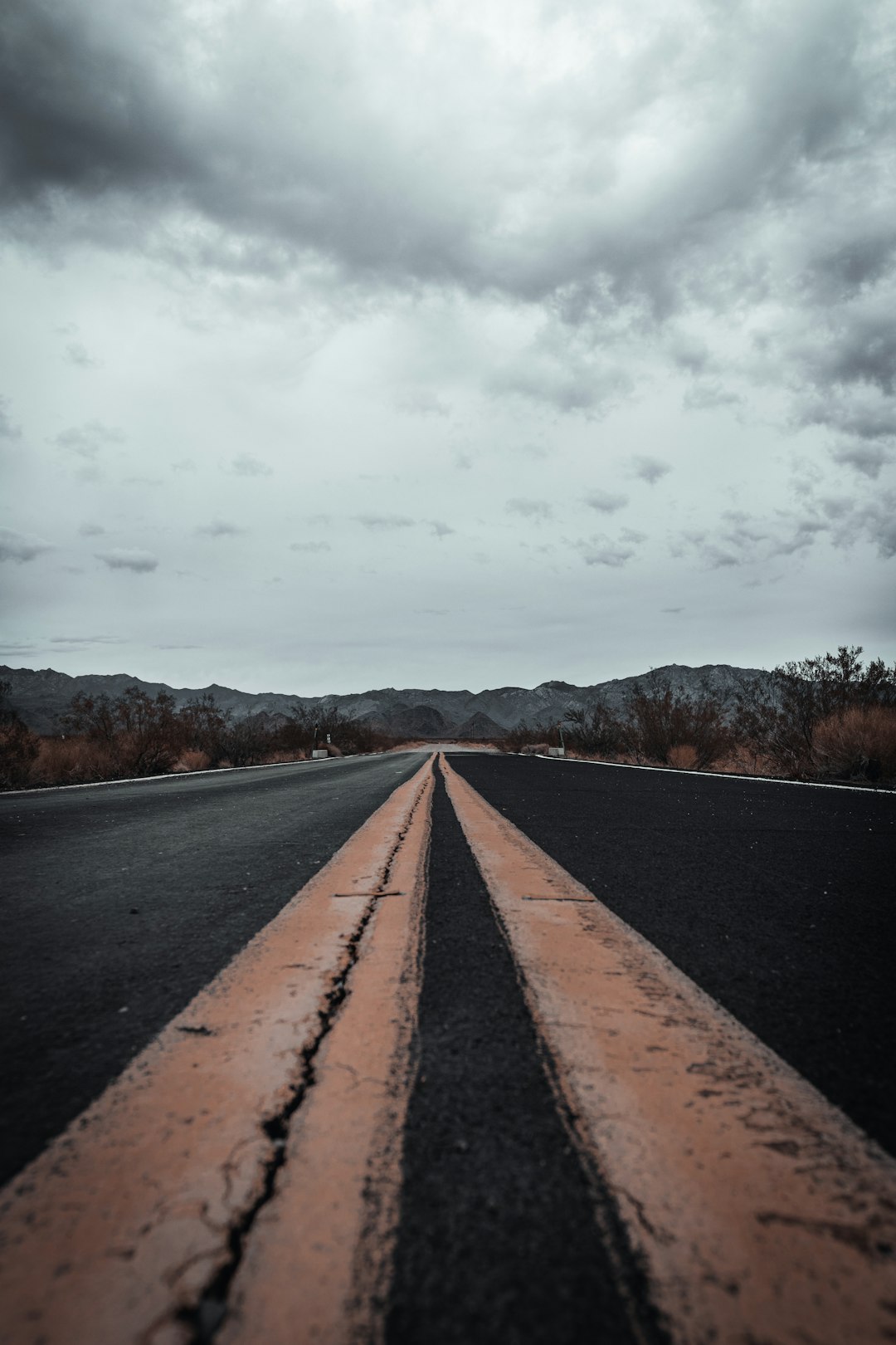 black asphalt road under white cloudy sky during daytime