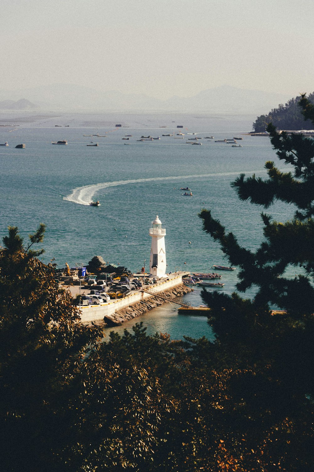 white lighthouse near body of water during daytime