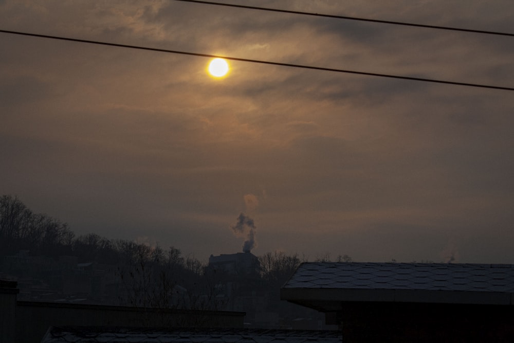 silhouette of man standing on roof during sunset