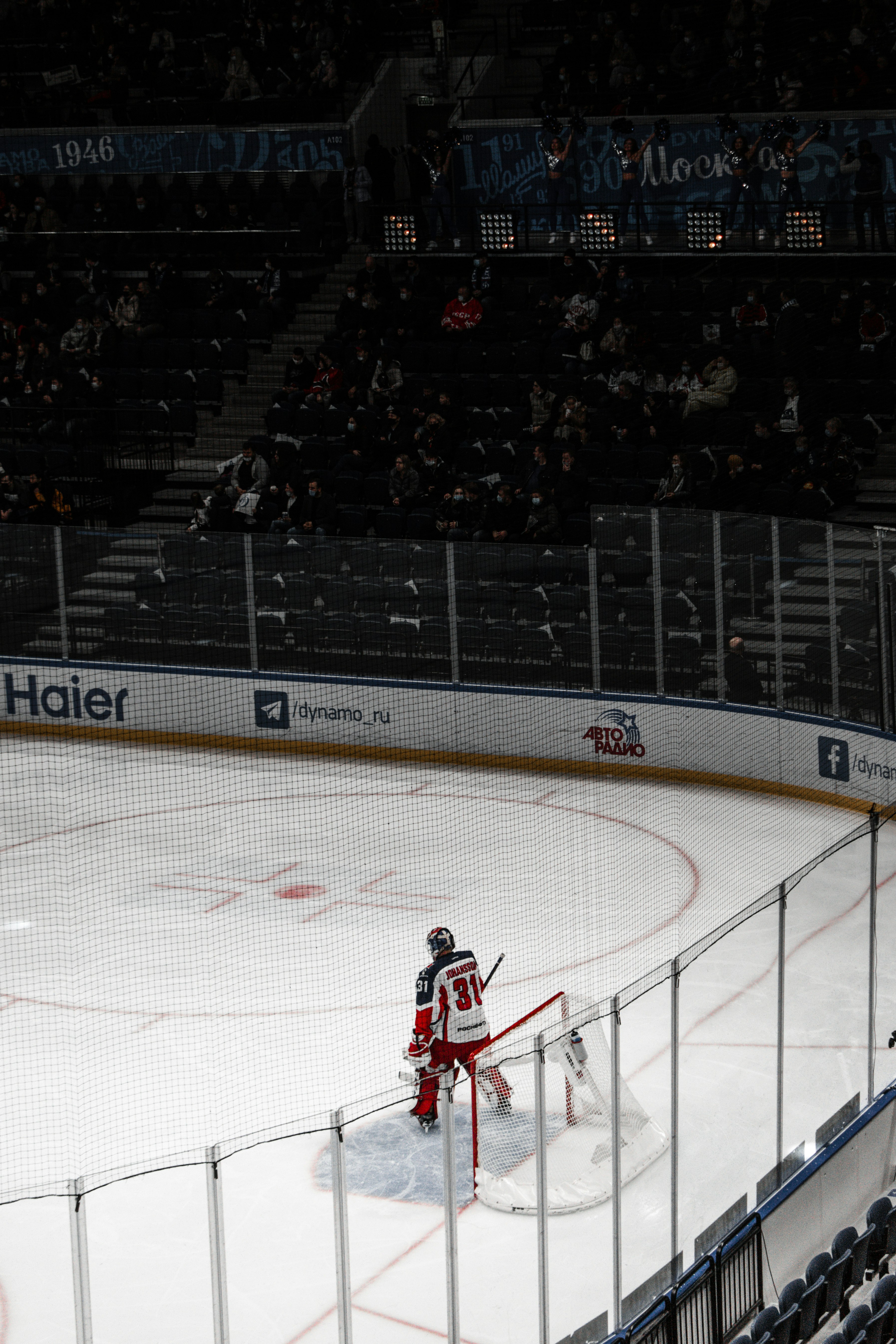 man in red jersey shirt playing ice hockey