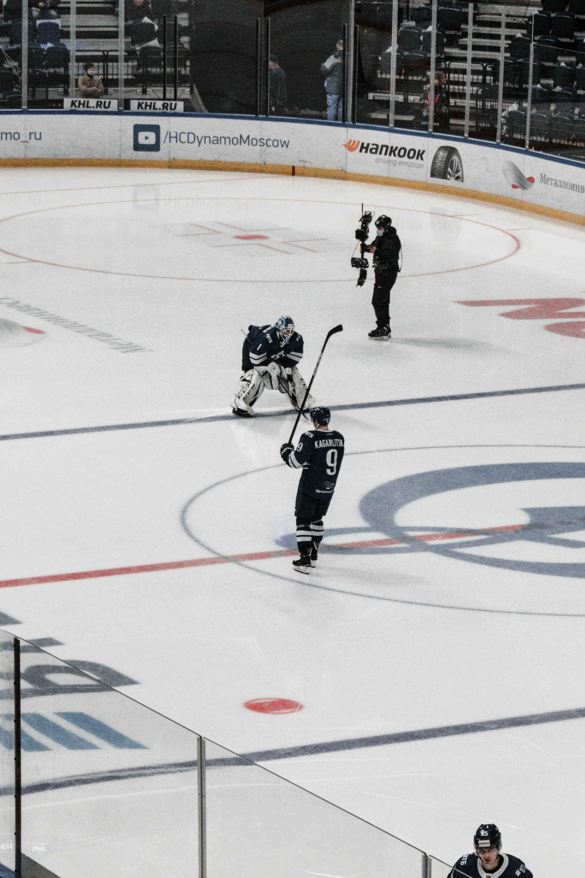 man in black and white ice hockey jersey playing hockey