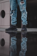 person in brown pants and white converse all star high top sneakers