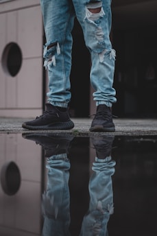 person in brown pants and white converse all star high top sneakers