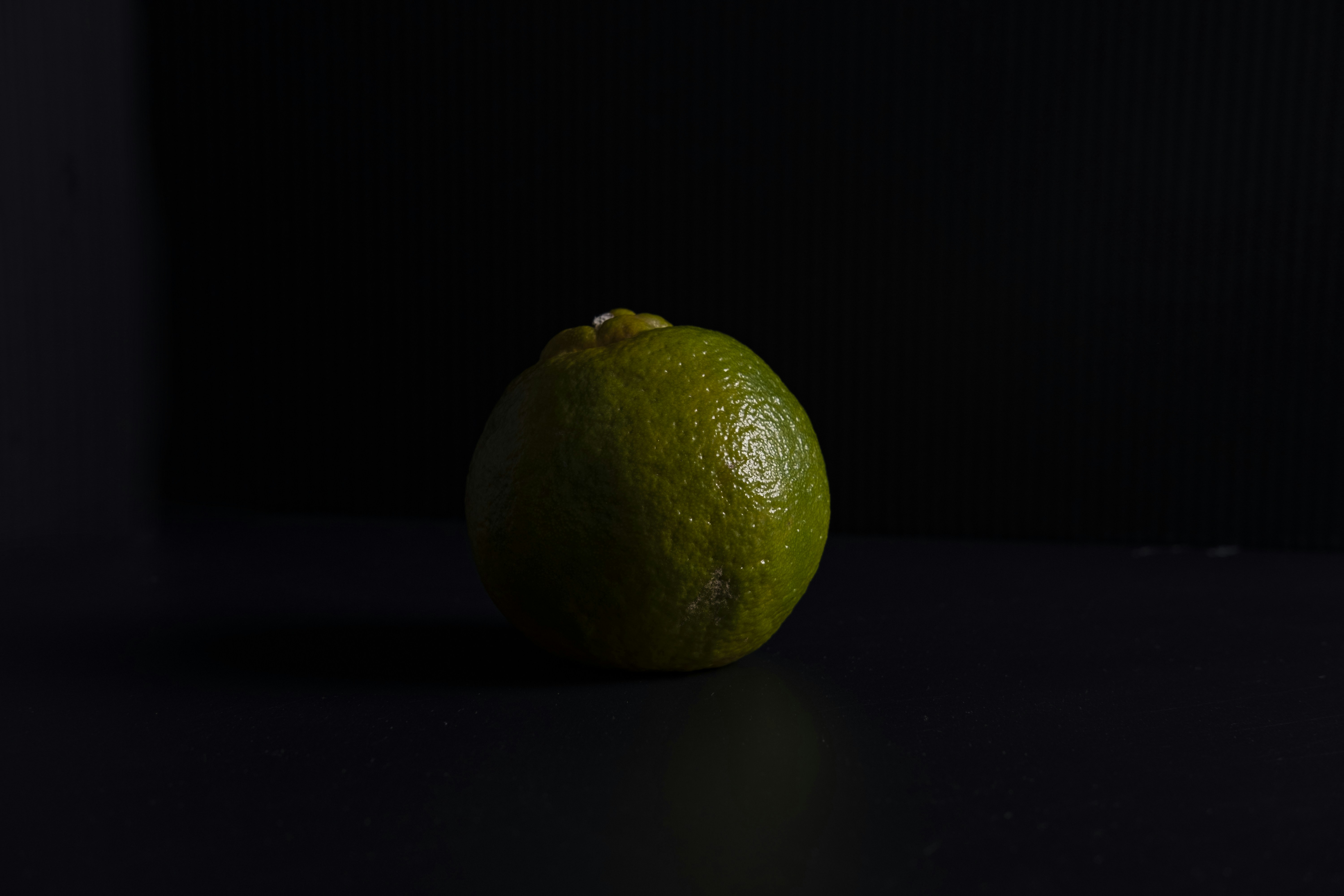 yellow lemon fruit on black surface