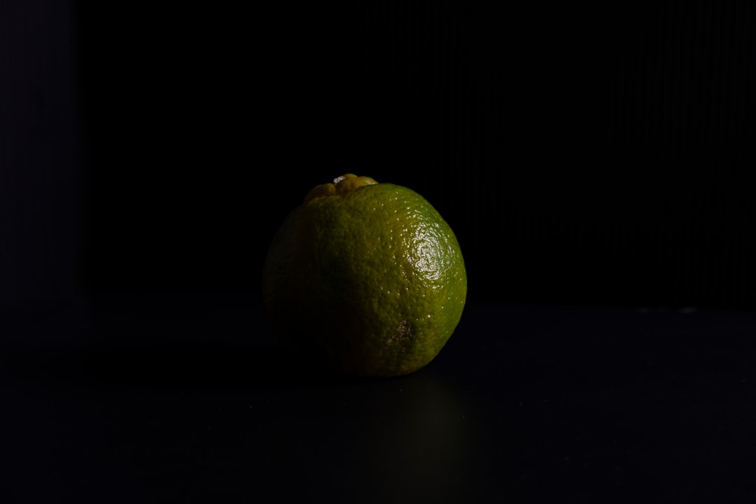 yellow lemon fruit on black surface