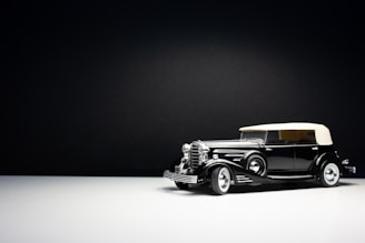 Minimalist studio photo of a convertible with soft shadows and off-white background.