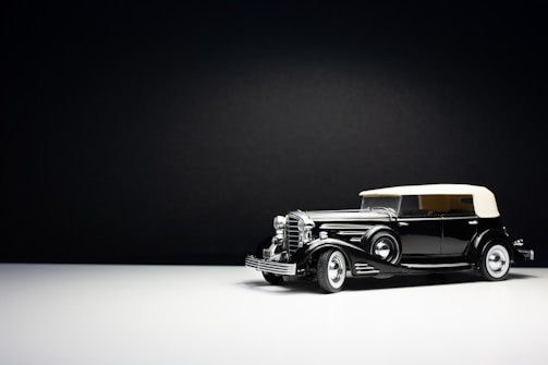 Minimalist silhouette of a classic car in elegant black and white tones.