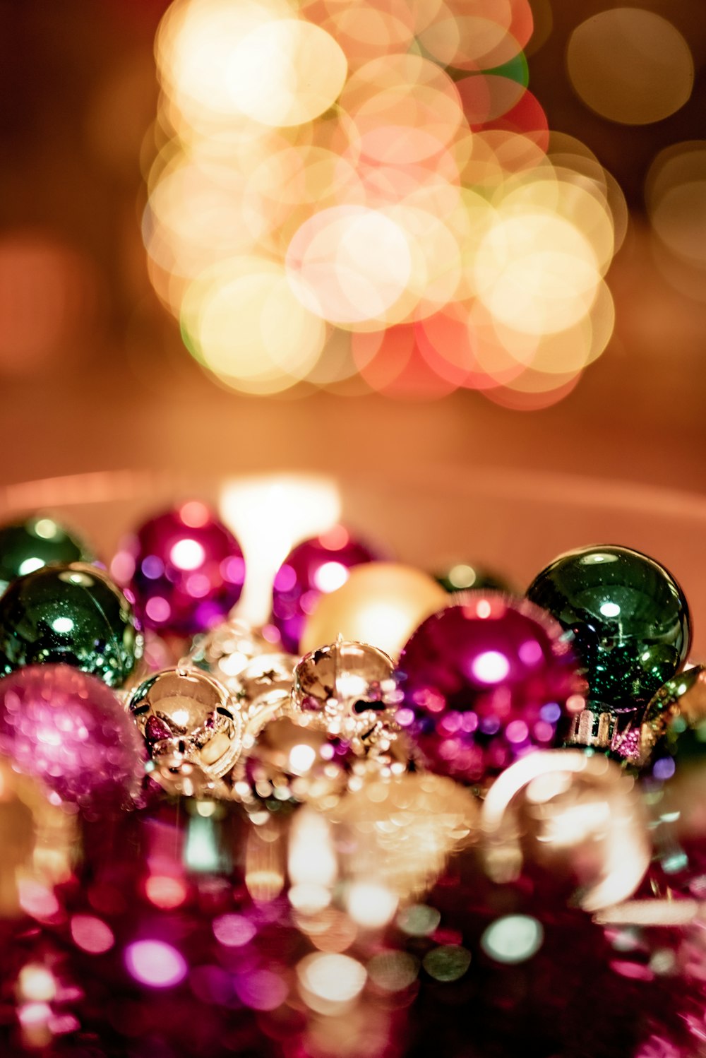 green and pink baubles on brown wooden table