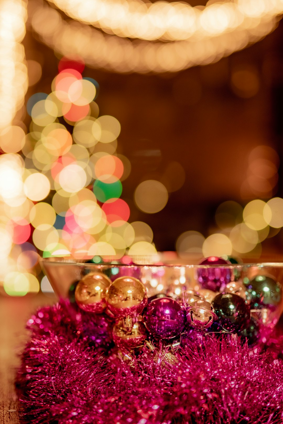 pink and gold baubles in clear glass cup