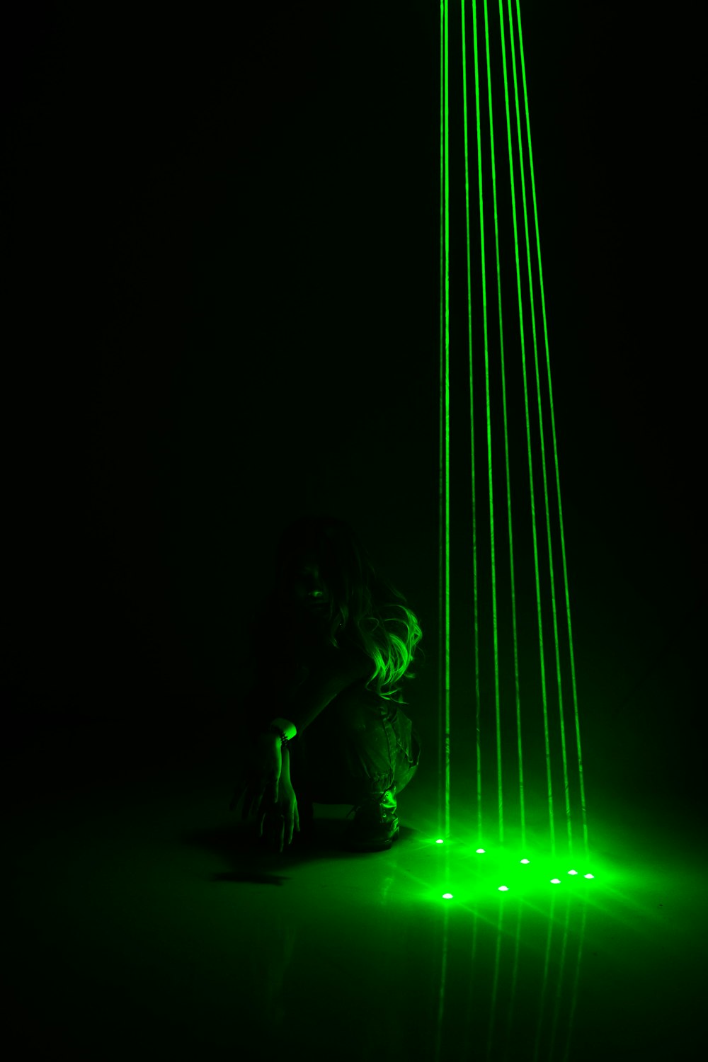 woman in green dress sitting on floor