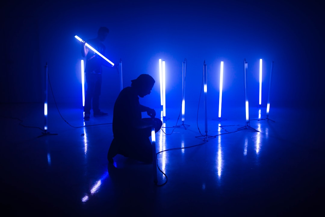 silhouette of man playing guitar on stage